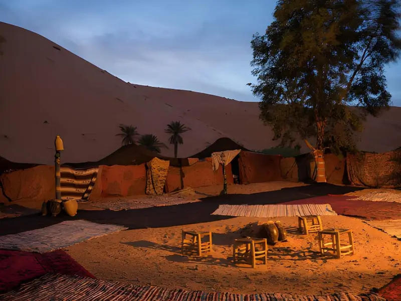 A traditional evening setup at a Sahara desert camp, offering a peaceful overnight experience for solo female travel Morocco.
